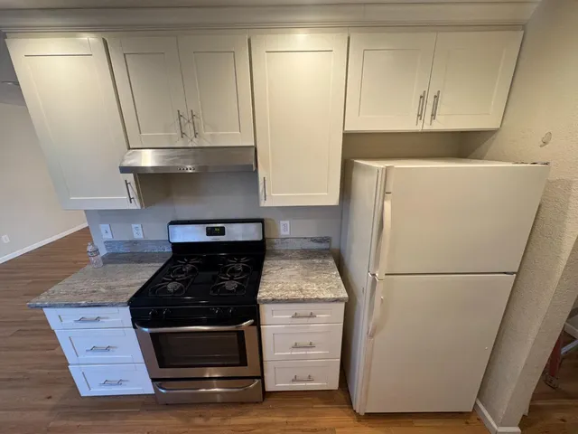 a kitchen with appliances and cabinets