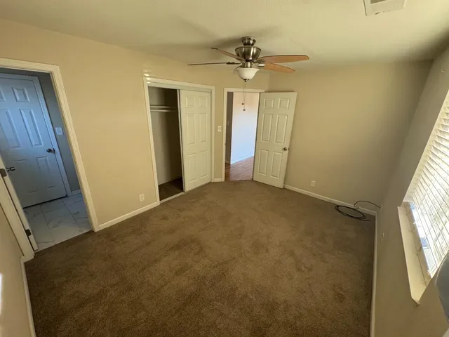 a view of an empty room and a window