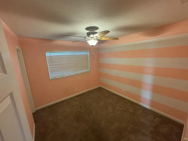 a view of a room with a ceiling fan and a chandelier fan