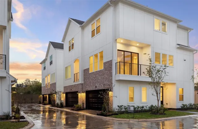 a front view of a building with lake view and car parked