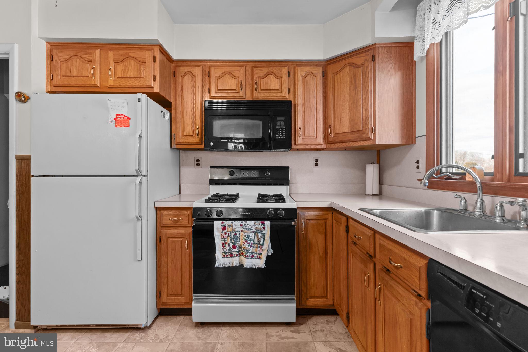 1001 Birch Road Warminster, PA 18974 - Photo 13 of 29 a kitchen with stainless steel appliances granite countertop a refrigerator a stove a sink and a window