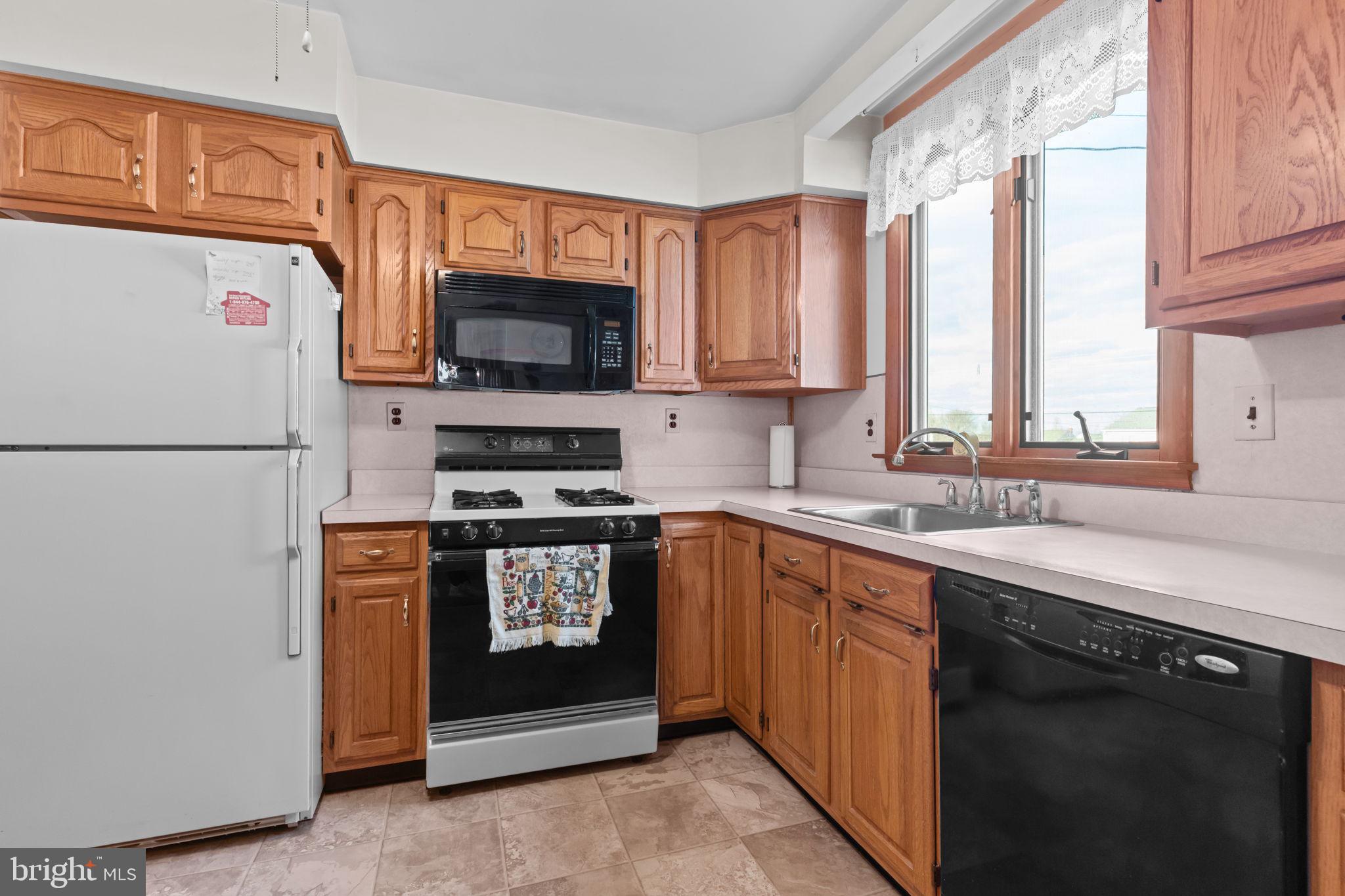 1001 Birch Road Warminster, PA 18974 - Photo 9 of 29 a kitchen with stainless steel appliances granite countertop a refrigerator a stove a sink and a microwave