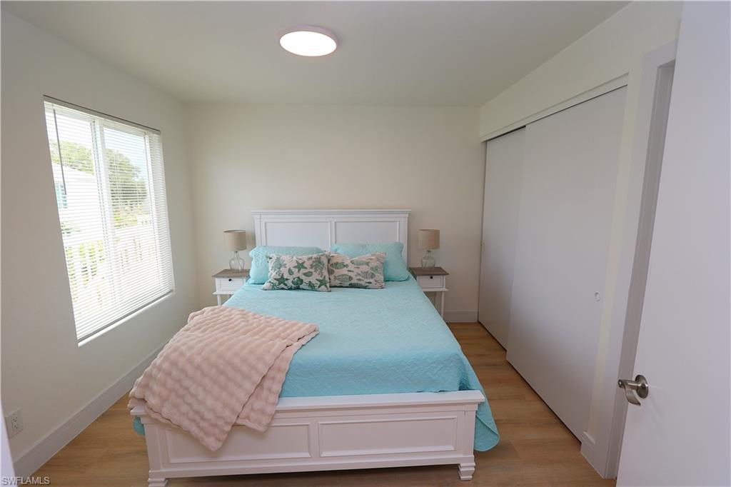 2235 San Marco Road, Unit 5204 Marco Island, FL 34145 - Photo 24 of 42 Bedroom with light wood-style flooring and a closet