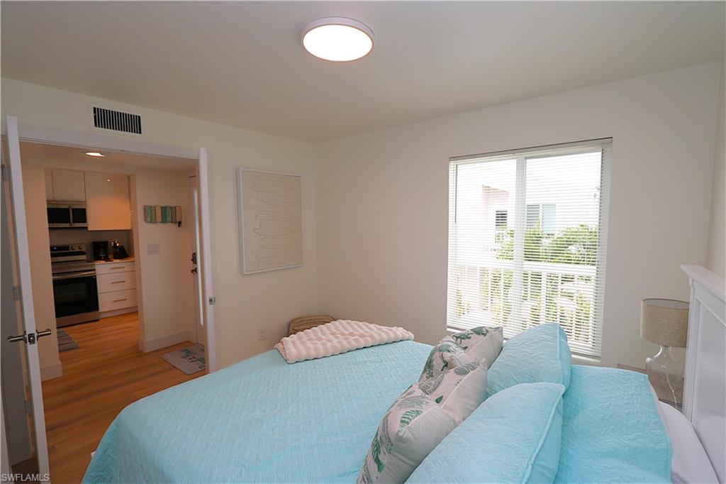 2235 San Marco Road, Unit 5204 Marco Island, FL 34145 - Photo 26 of 42 Bedroom featuring light wood-style floors and baseboards