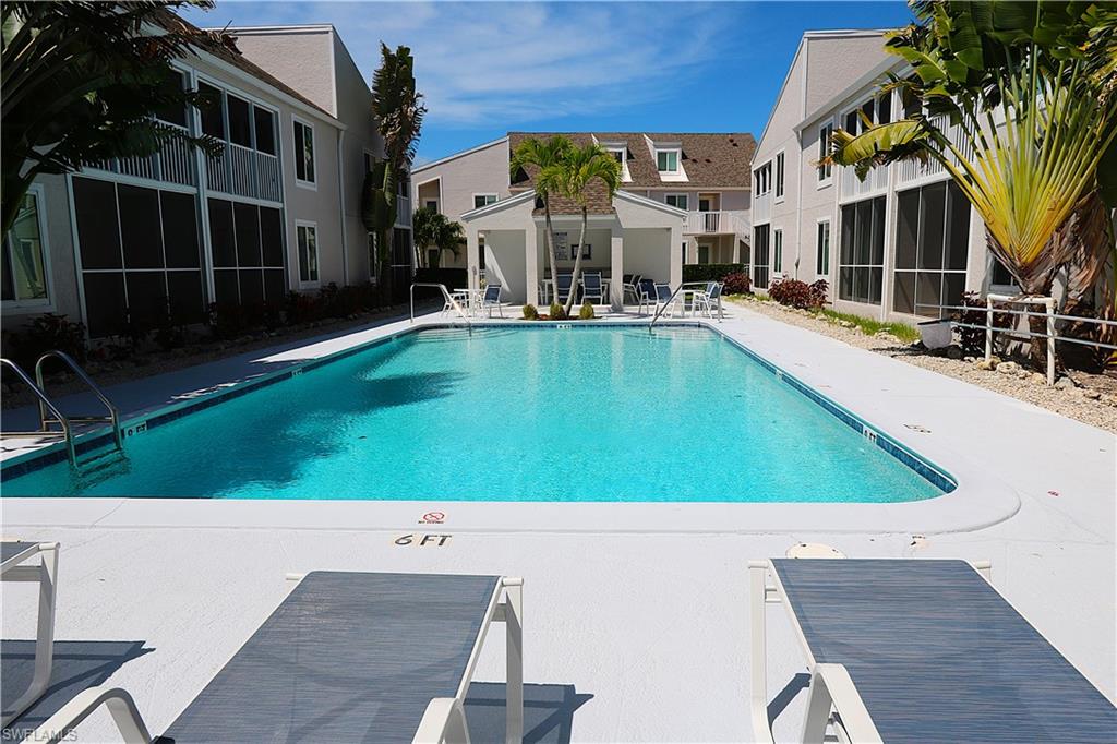2235 San Marco Road, Unit 5204 Marco Island, FL 34145 - Photo 39 of 42 Community pool featuring a patio and a sunroom