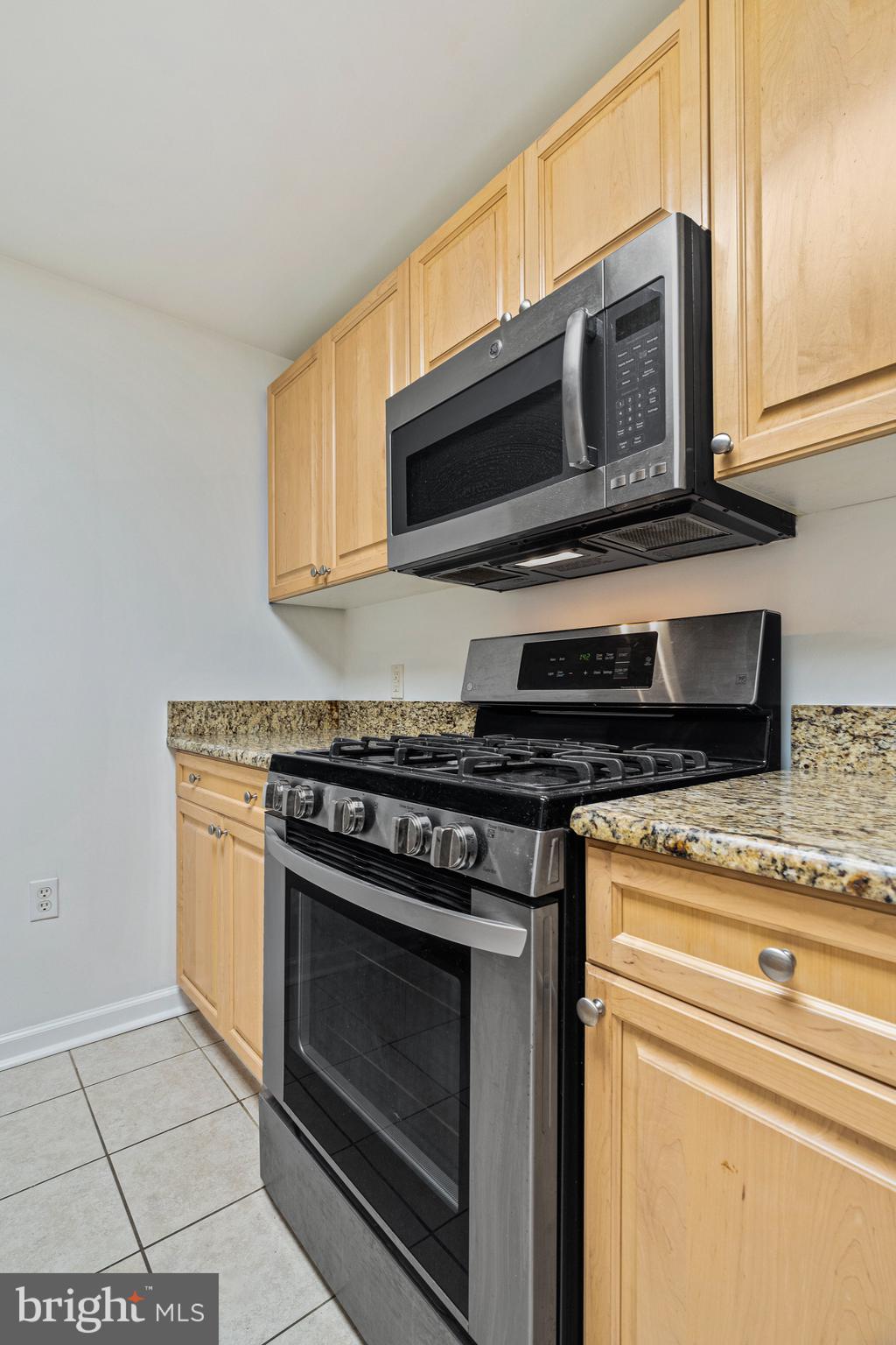2726 Gallows Road, Unit 712 Vienna, VA 22180 - Photo 6 of 55 a kitchen with stainless steel appliances granite countertop a stove microwave and oven