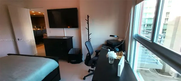 a bed room with a bed and teddy bear on bed