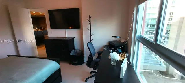 a bed room with a bed and teddy bear on bed