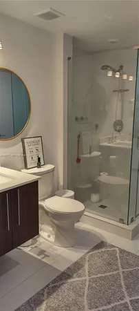a bathroom with a sink toilet and shower