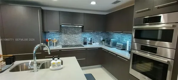 a living room with furniture and a glass door