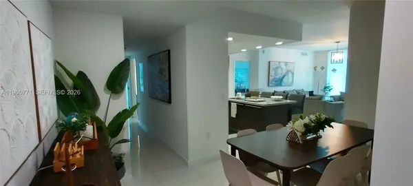 a kitchen with kitchen island stainless steel appliances a sink and a refrigerator