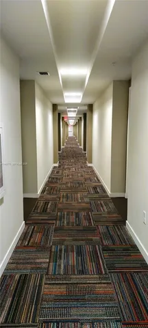 a living room with furniture a large window and wooden floor