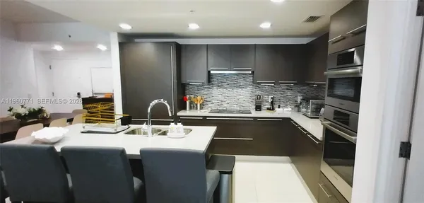 a kitchen with a stove a sink and a refrigerator