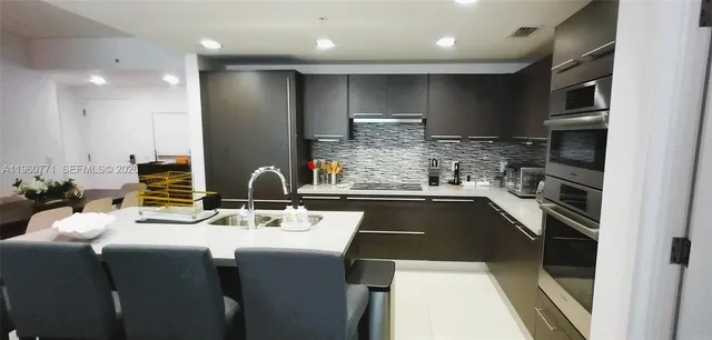 a kitchen with a stove a sink and a refrigerator