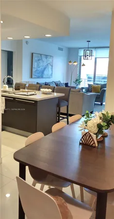 a kitchen with stainless steel appliances kitchen island granite countertop a sink and cabinets