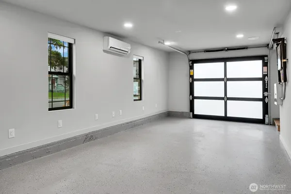 an empty room with windows and closet