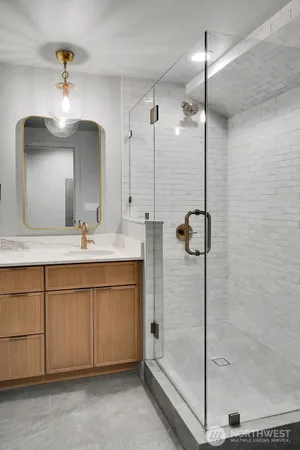a bathroom with a double vanity sink a mirror and shower