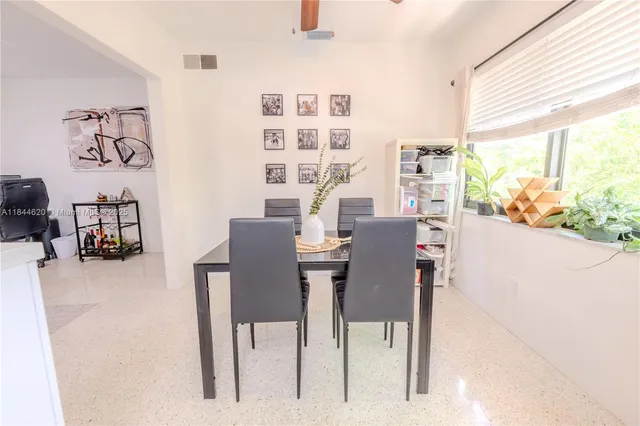 a view of a dining room with furniture and a large window