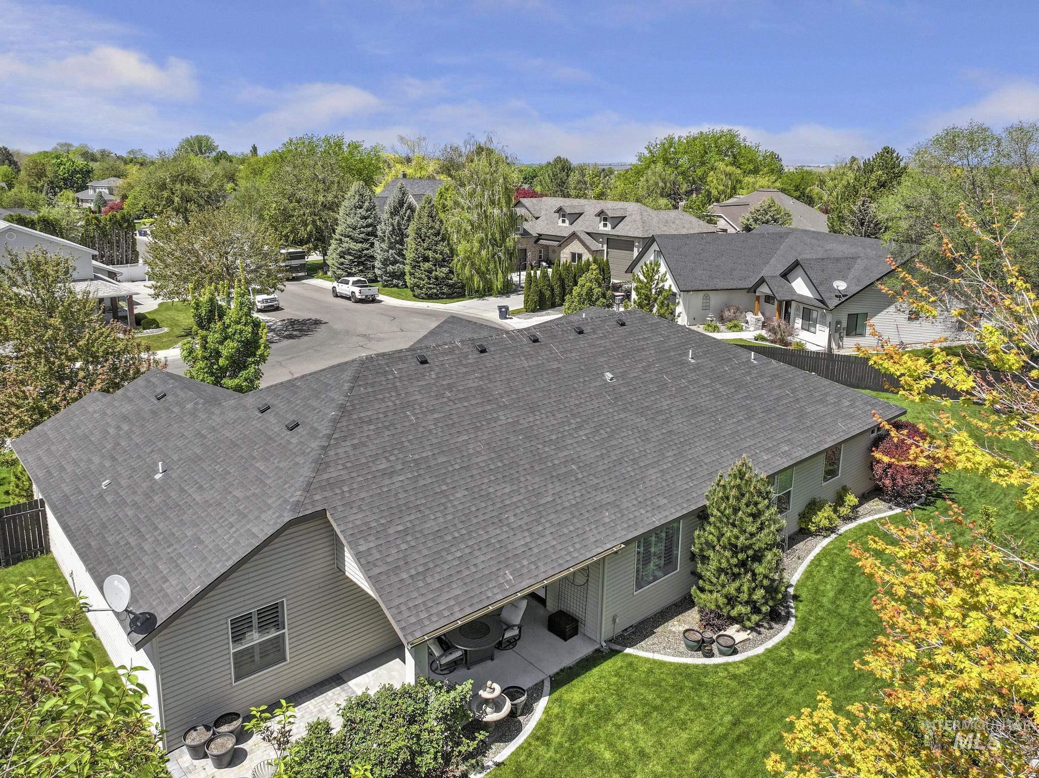 1937 Tamarack Loop Twin Falls, ID 83301 - Photo 46 of 50 Rear exterior with a concrete patio, expansive lawn, and mature landscaping