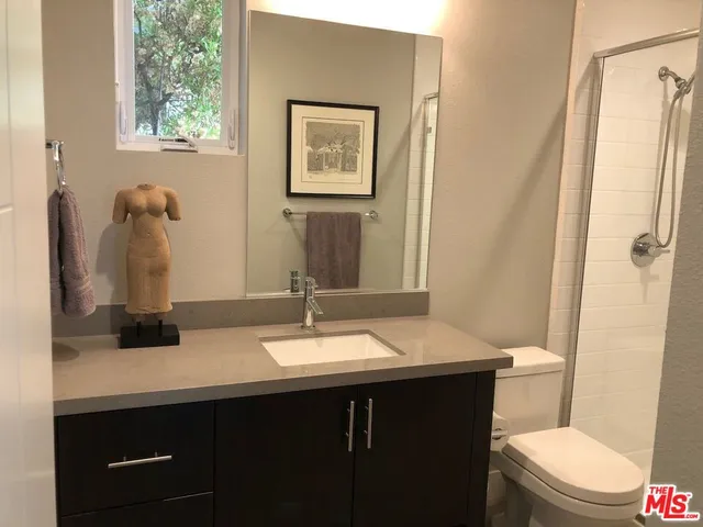 a view of staircase with lots of frames on wall and windows