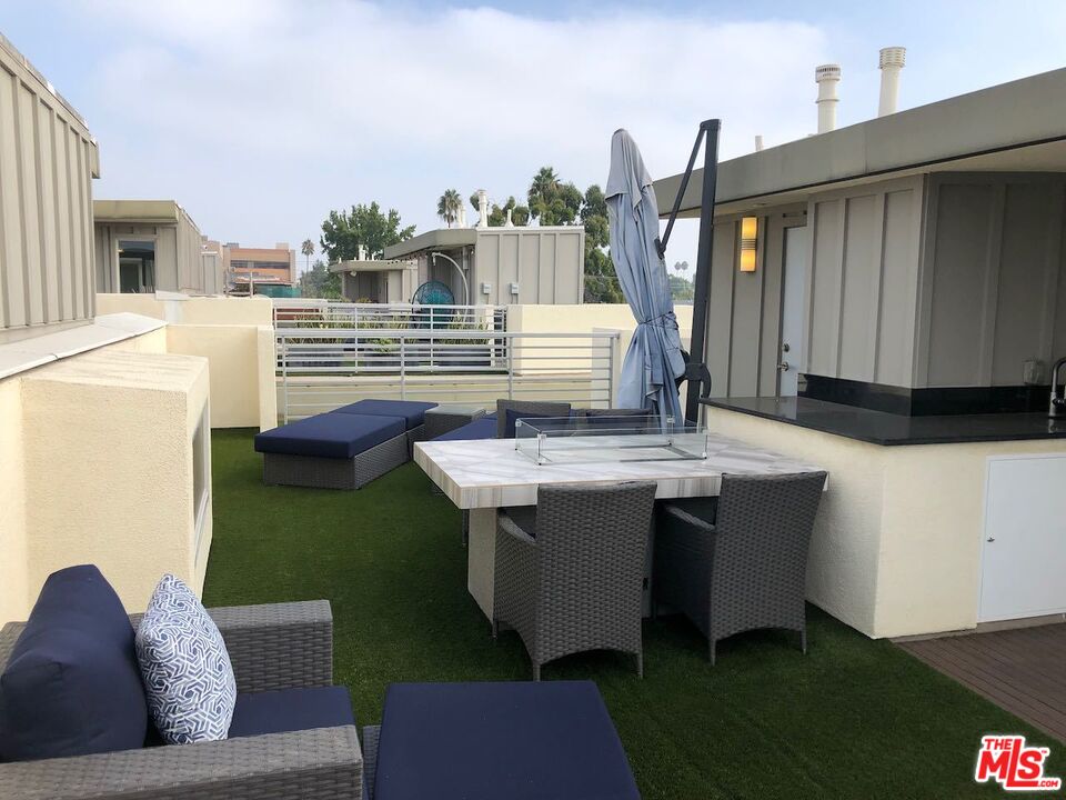 12003 Emery Lane Valley Village, CA 91607 - Photo 20 of 22 a view of roof deck with couches table and chairs