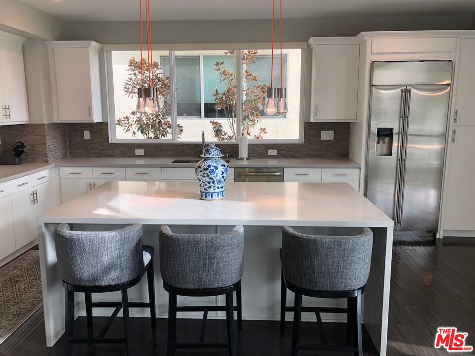 12003 Emery Lane Valley Village, CA 91607 - Photo 7 of 22 a kitchen with a dining table chairs and chandelier