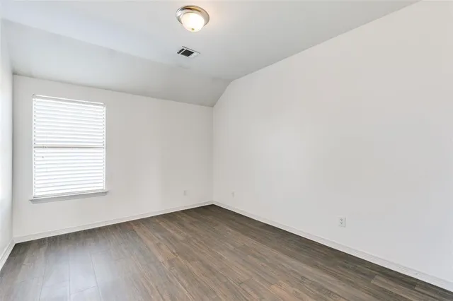 a view of a livingroom with wooden floor and a ceiling fan