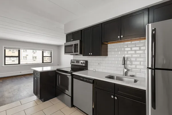 a kitchen with a sink a stove and refrigerator