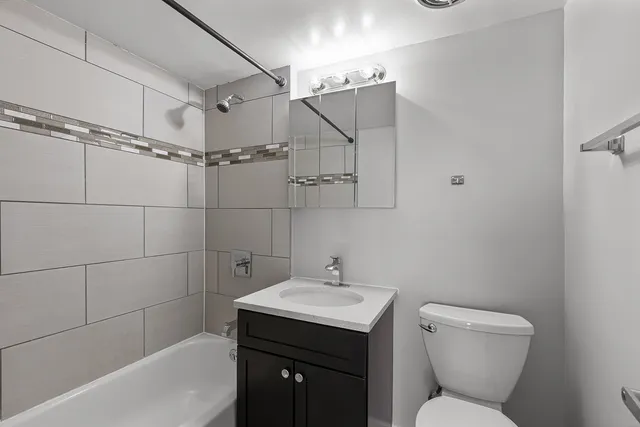 a bathroom with a toilet sink and shower