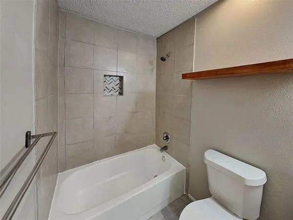 a bathroom with a toilet and bathtub