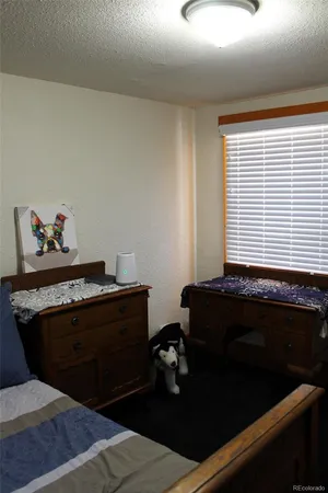 a room with a bed and a dresser