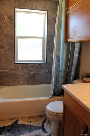 a bathroom with a sink a toilet and bathtub