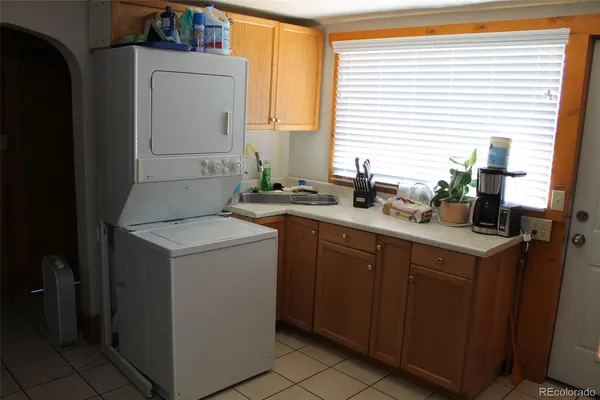 a utility room with cabinets washer and dryer