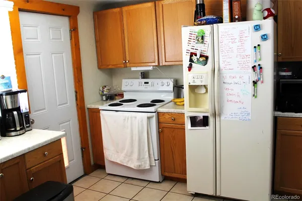 a kitchen with a refrigerator and a stove