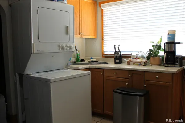 a utility room with cabinets washer and dryer