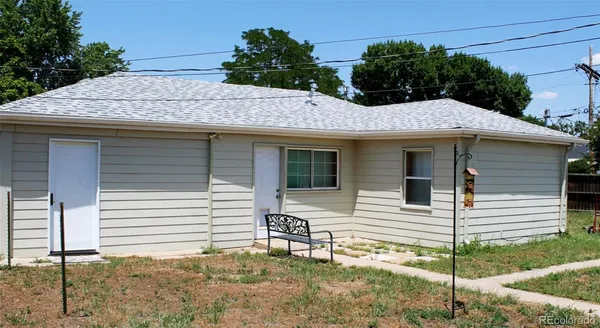 a side view of a house with a porch