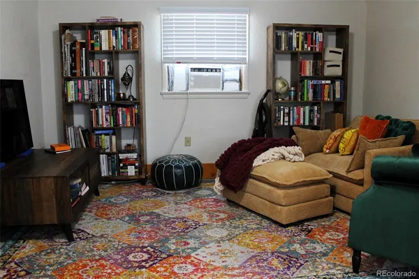 a bedroom with furniture and a book shelf