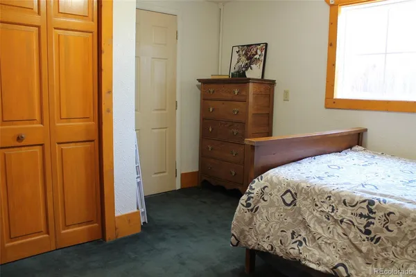 a bedroom with a bed and a dresser