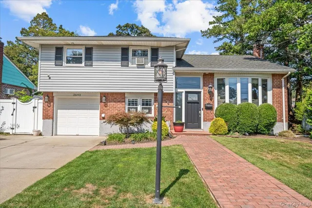 a front view of a house with a yard and porch