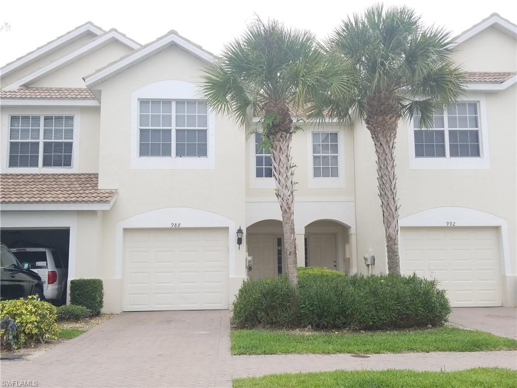 988 Hampton Circle, Unit 73 Naples, FL 34105 - Photo 1 of 22 a front view of a house with garden