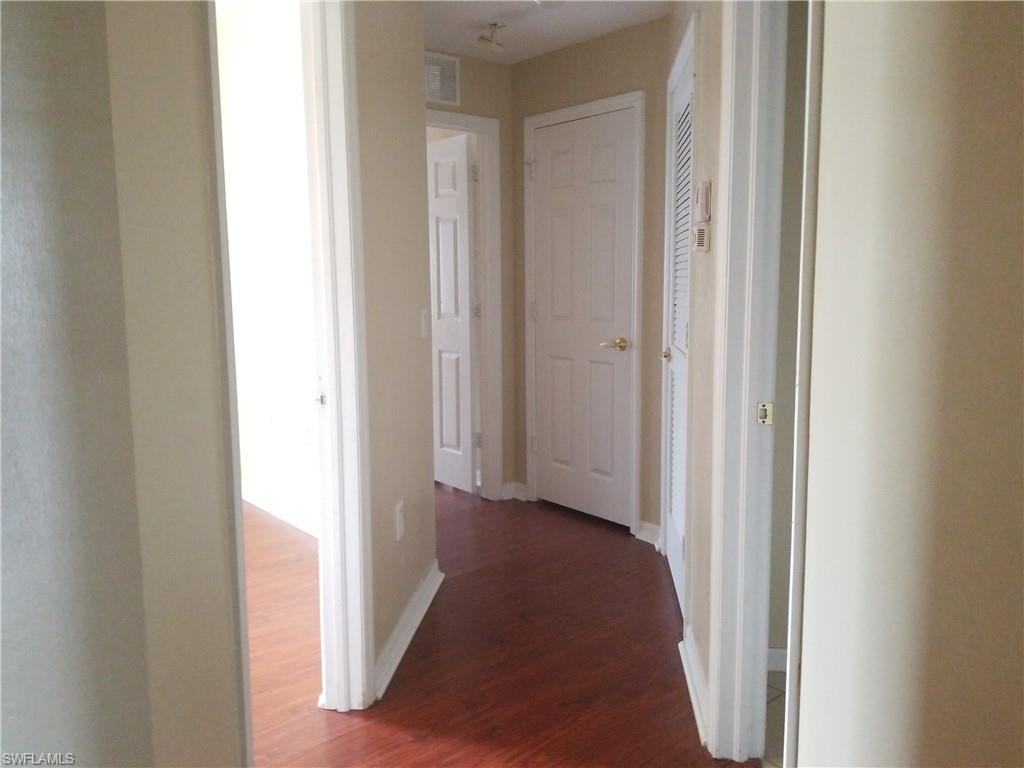 988 Hampton Circle, Unit 73 Naples, FL 34105 - Photo 12 of 22 a view of a hallway with a hallway