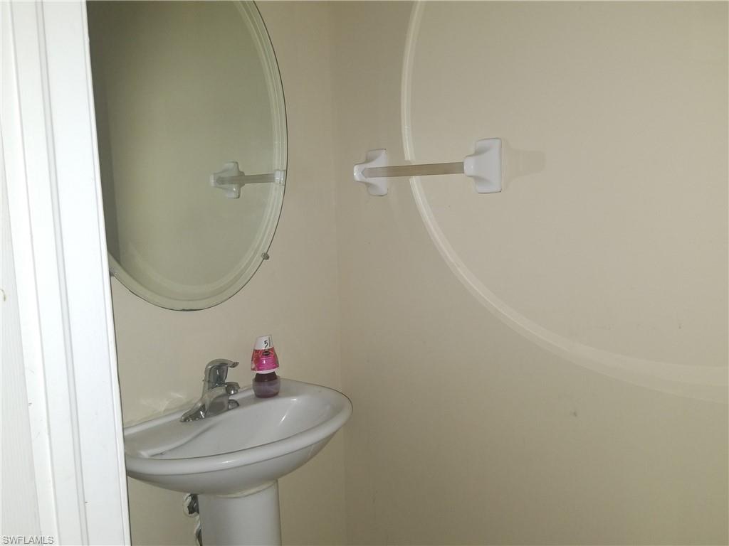 988 Hampton Circle, Unit 73 Naples, FL 34105 - Photo 17 of 22 a bathroom with a sink and a mirror