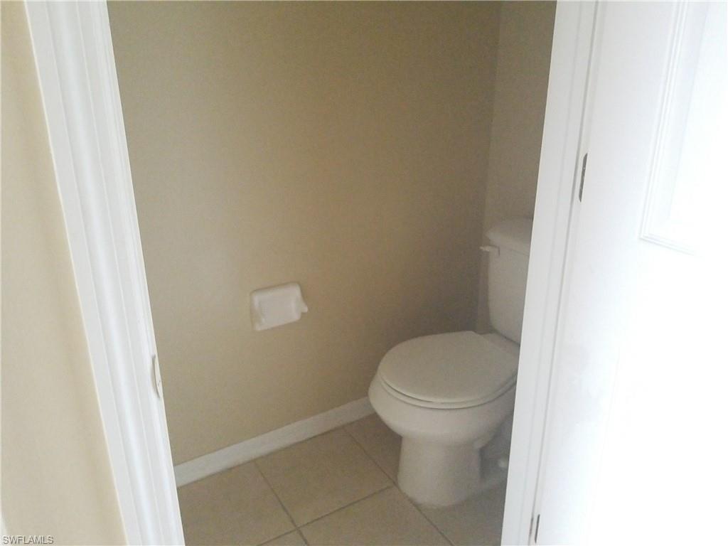 988 Hampton Circle, Unit 73 Naples, FL 34105 - Photo 18 of 22 a white toilet sitting next to a white cabinet