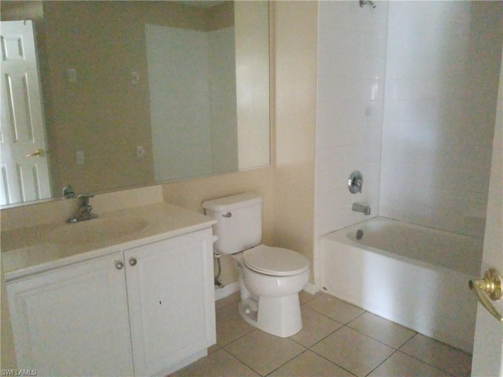 988 Hampton Circle, Unit 73 Naples, FL 34105 - Photo 19 of 22 a bathroom with a sink toilet and bathtub