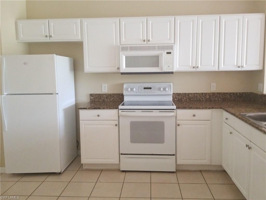 988 Hampton Circle, Unit 73 Naples, FL 34105 - Photo 6 of 22 a utility room with dryer and washer