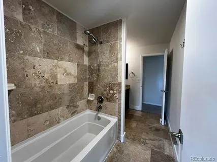 a bathroom with a bathtub and a shower