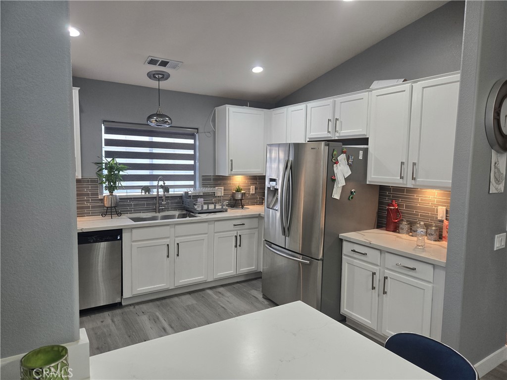 33860 Bell Thousand Palms, CA 92276 - Photo 11 of 49 a kitchen with stainless steel appliances a refrigerator sink and cabinets