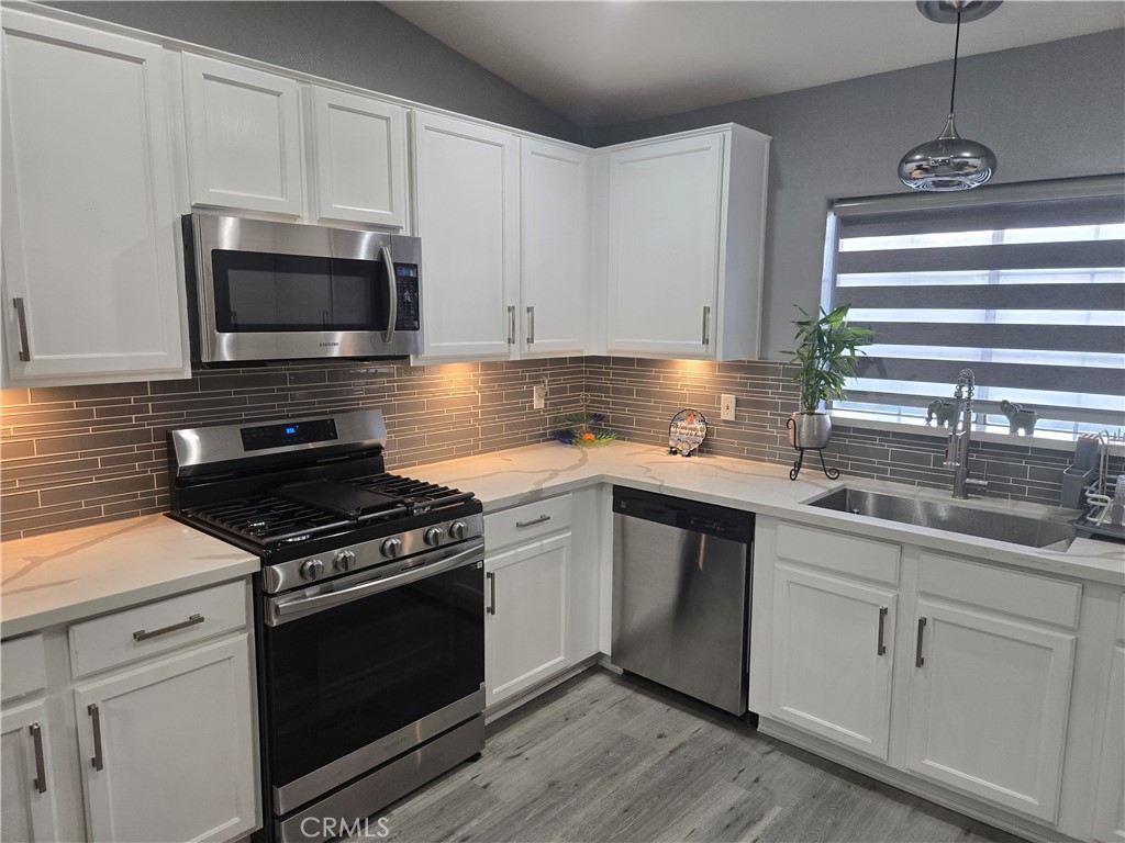 33860 Bell Thousand Palms, CA 92276 - Photo 12 of 49 a kitchen with granite countertop a sink cabinets and stainless steel appliances