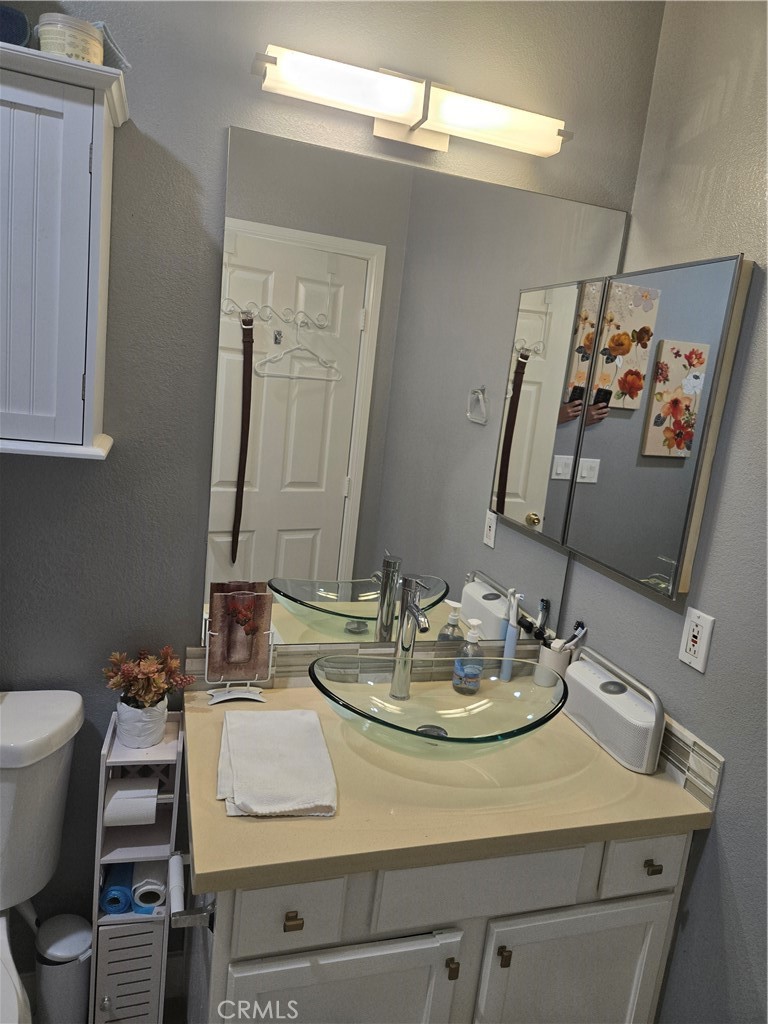 33860 Bell Thousand Palms, CA 92276 - Photo 16 of 49 a bathroom with a sink and a mirror