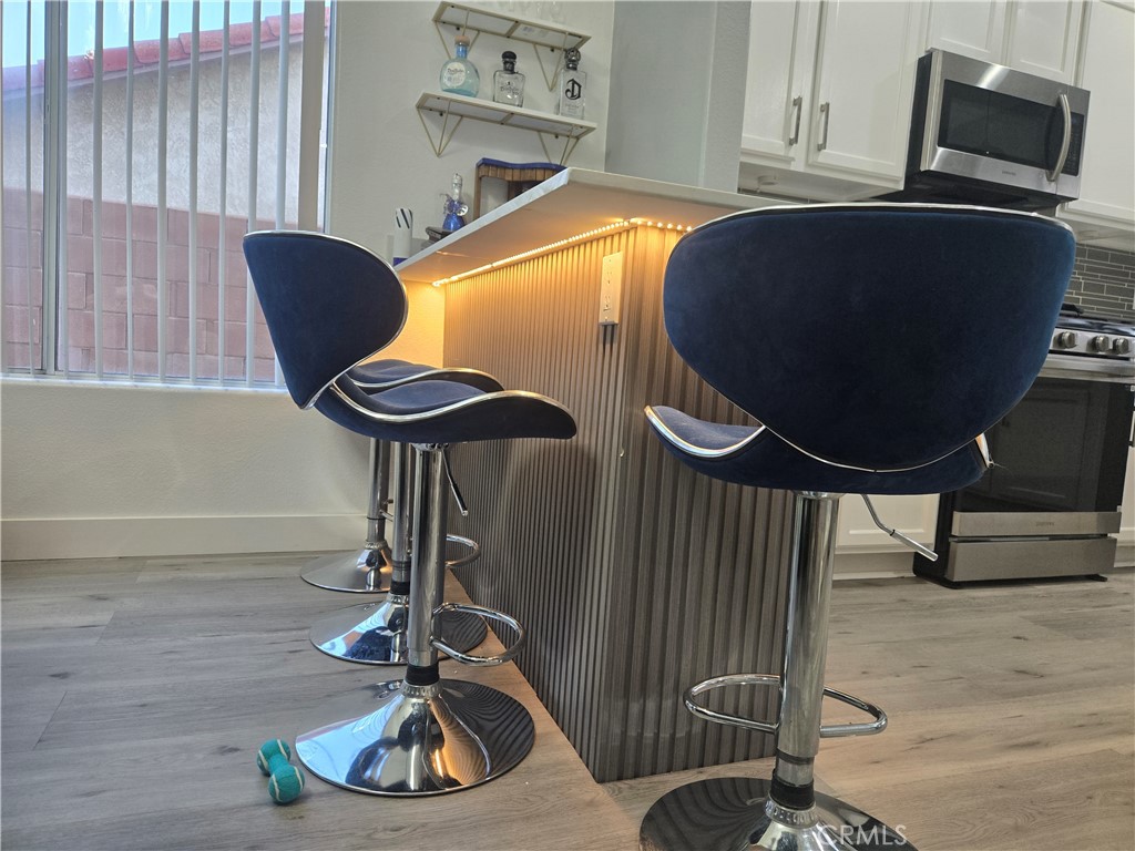 33860 Bell Thousand Palms, CA 92276 - Photo 38 of 49 a view of a kitchen area with furniture and wooden floor